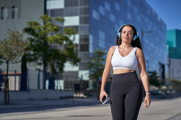 写真 都市の建物に立っている若い女性の肖像画