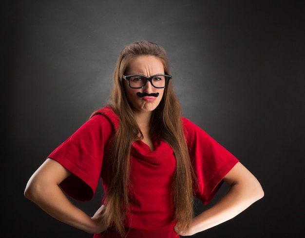 Portrait of offended girl with fake mustaches