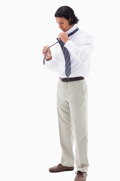 Portrait of an office worker putting his tie