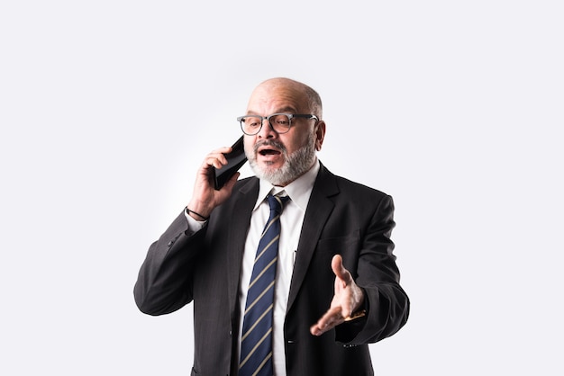 Portrait of old Indian asian businessman using smartphone for messaging, calling or showing or presenting against white background