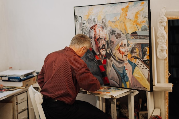 Portrait of old painter painting Revolution Ukraine 2014