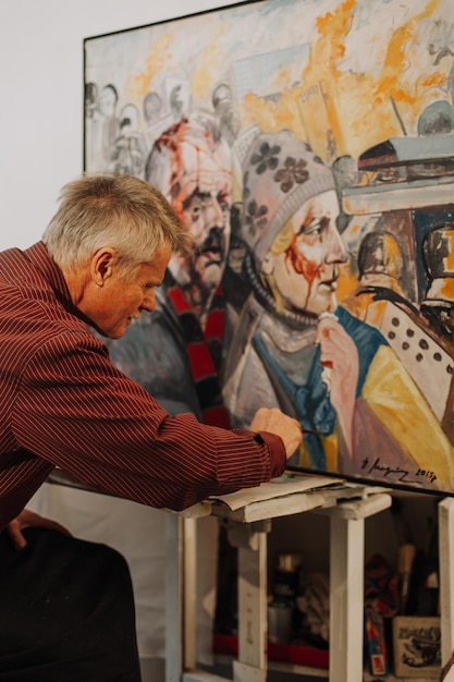 Portrait of old painter painting Revolution Ukraine 2014