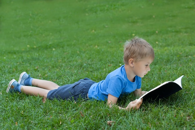 Portrait of one cute boy he draws in park Education School Notebook