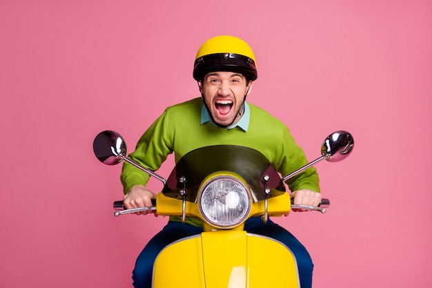 Portrait of overjoyed guy riding motorbike scream open mouth