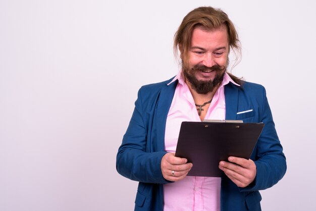 Portrait of overweight bearded businessman with mustache and long hair against white wall