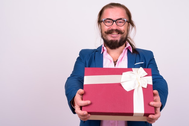 Portrait of overweight bearded businessman with mustache and long hair against white wall