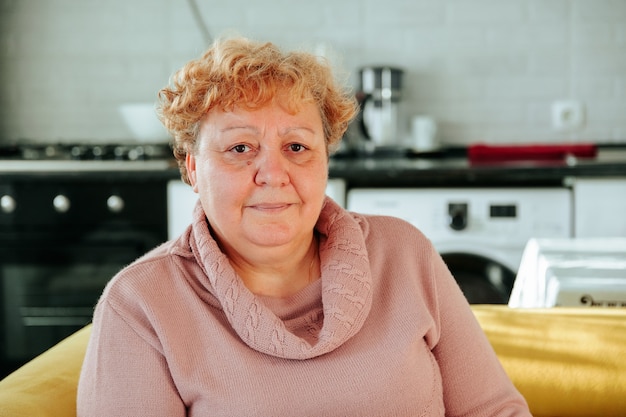 Portrait of an overweight elderly woman looking at camera problems with extra kilograms in people