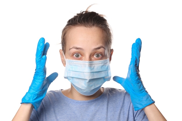 Portrait of panic woman in a medical mask and gloves isolated on white. Pandemic protection covid-19