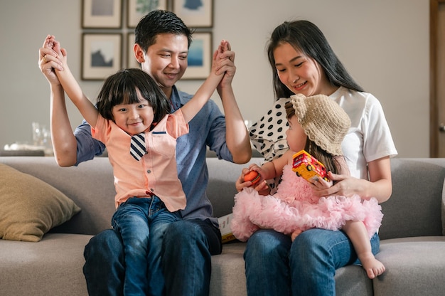 Portrait of parents happy full family with children have fun sitting on sofa in living room leisure activities spend time at homeWeekend activity happy family lifestyle concept