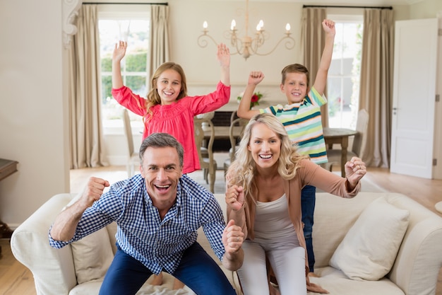 Portrait of parents and kids having fun in living room