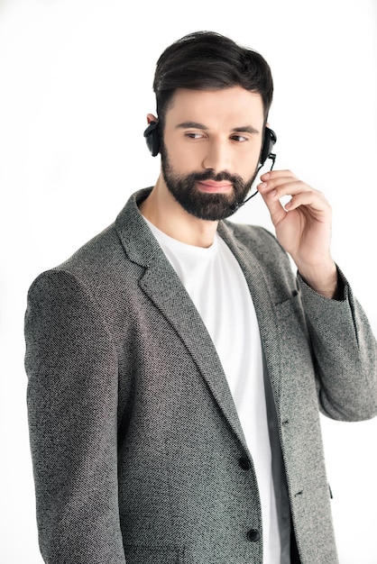 Portrait of pensive call center operator in headset isolated on white