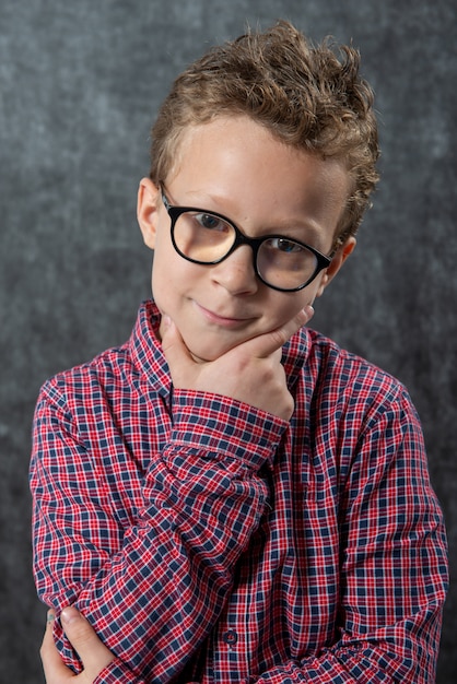 Portrait of pensive cute child with checkered shirt