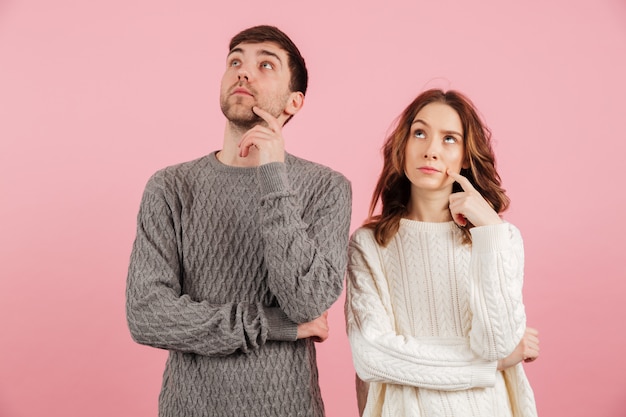 Portrait of pensive loving couple dressed in sweaters