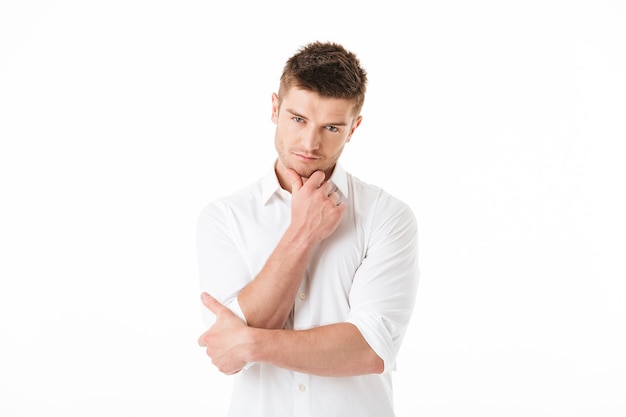 Portrait of a pensive young man looking at camera