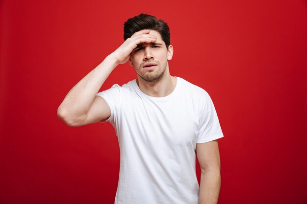 Portrait of a pensive young man in white t-shirt