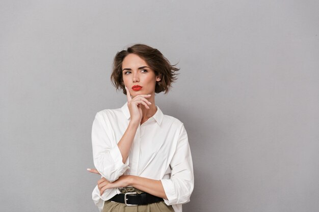 Portrait of a pensive young woman dressed in white shirt