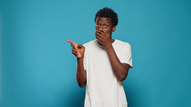 Portrait of person covering mouth with hands after telling secret