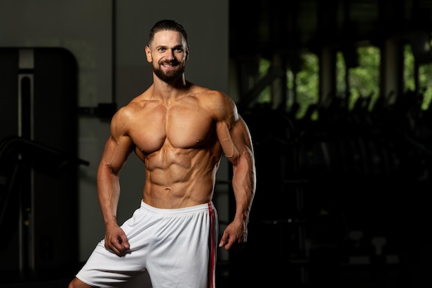 Portrait Of Personal Trainer In Sports Outfit In Fitness Center Gym Standing Strong