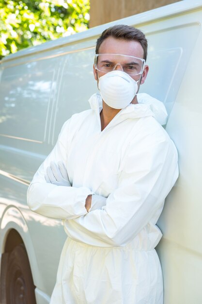 Portrait of pest control man standing next to a van