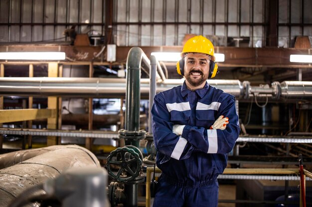 Photo portrait of petrochemical refinery worker wearing earmuff due to noisy environment in factory