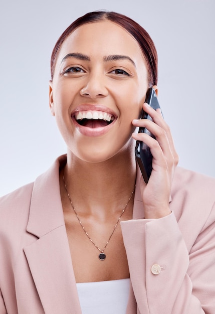 Portrait phone call and funny woman in communication in studio isolated on a white background Face smartphone and happy person in business conversation talking and laugh at contact in discussion