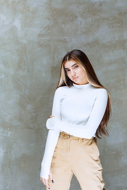 Portrait photo of a beautiful girl model standing and looking at camera 