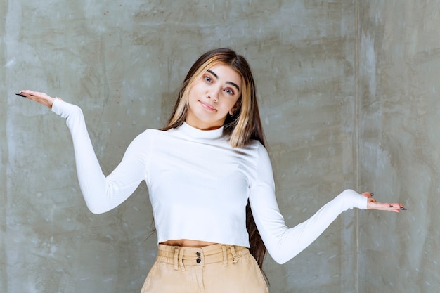 Portrait photo of a beautiful girl model standing and looking at camera 