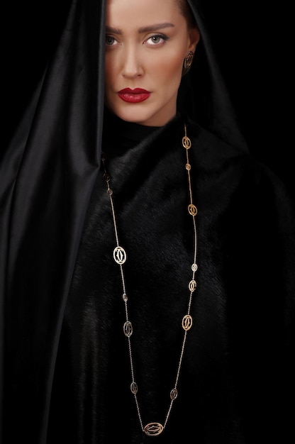 Portrait photo of charming woman with long necklace and black dress