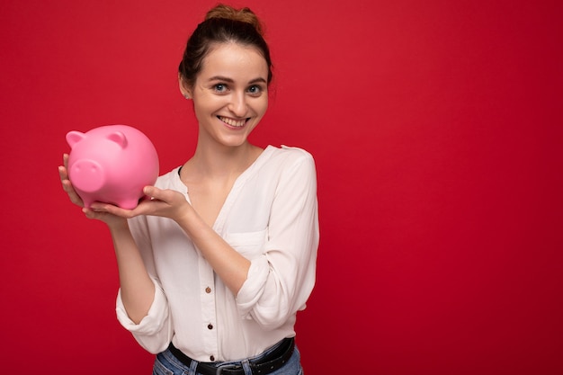 Portrait photo of happy positive smiling young beautiful attractive woman with dark hair in a bun