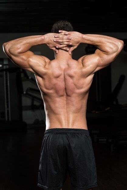 Portrait Of A Physically Fit Man Posing In Modern Fitness Center Gym