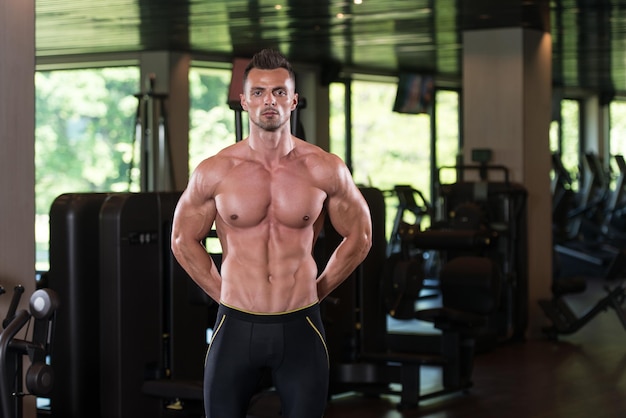 Portrait Of A Physically Fit Man Posing In Modern Fitness Center Gym