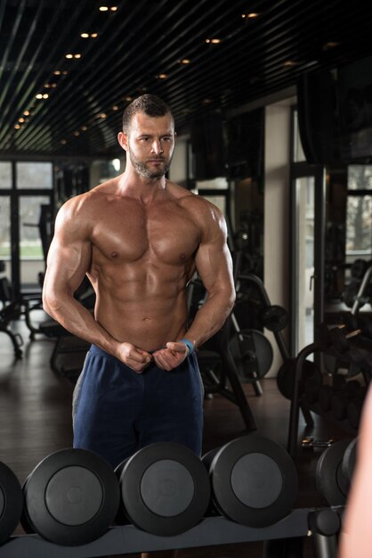 Portrait Of A Physically Fit Man Posing In Modern Fitness Center Gym