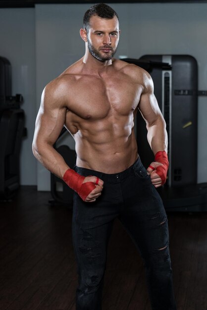 Portrait Of A Physically Fit Man Posing In Modern Fitness Center Gym