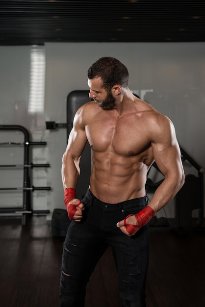 Portrait Of A Physically Fit Man Posing In Modern Fitness Center Gym