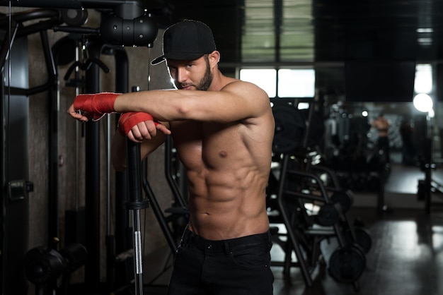 Portrait Of A Physically Fit Man Showing His Well Trained Body In Gym