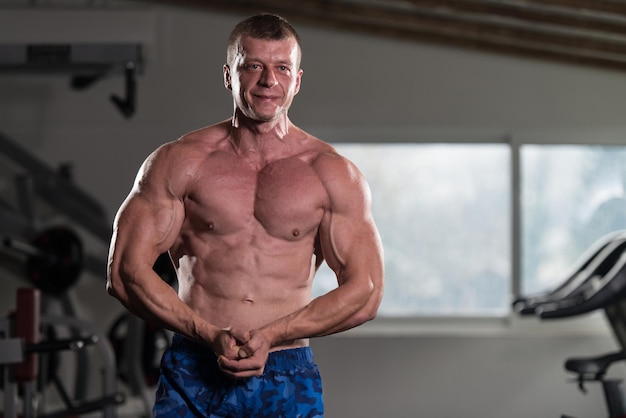 Portrait Of A Physically Fit Man Showing His Well Trained Body  Muscular Athletic Bodybuilder Fitness Model Posing After Exercises