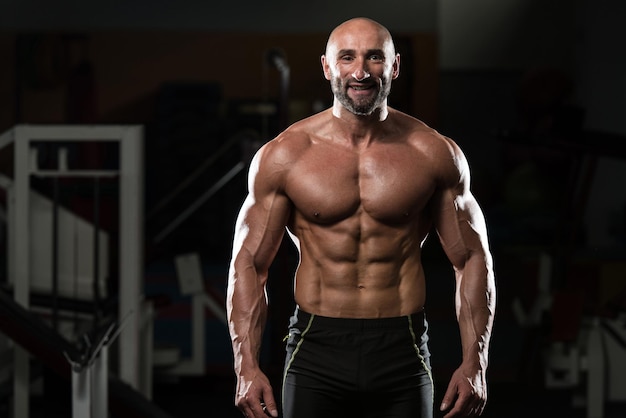 Portrait Of A Physically Fit Mature Man In A Healthy Club With Dramatic Lighting