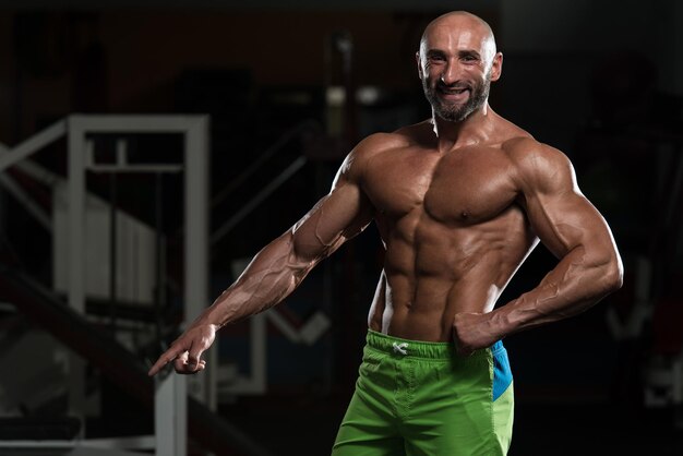 Portrait Of A Physically Fit Mature Man In A Healthy Club With Dramatic Lighting