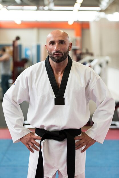 Portrait Of A Physically Fit Mature Man In Kimono With Black Belt