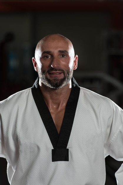 Portrait Of A Physically Fit Mature Man In Kimono With Black Belt