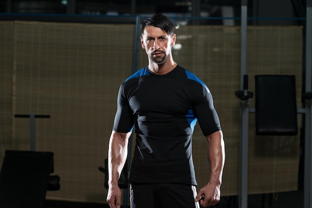 Portrait Of A Physically Fit Young Man  Flexing Muscles