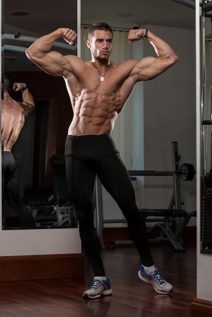 Portrait Of A Physically Fit Young Man  Flexing Muscles