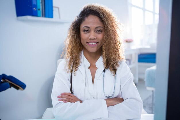 Portrait of physiotherapist standing with arms crossed