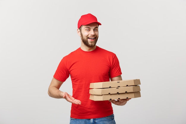 Portrait of Pizza delivery man presenting something in box. Isolated white background.