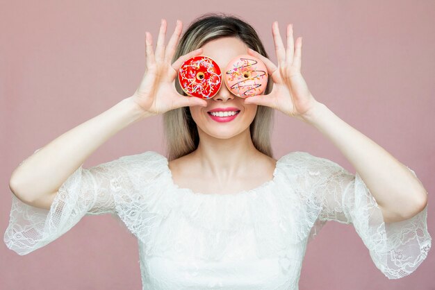 portrait playful woman with donuts