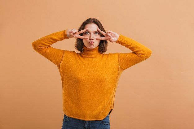 Portrait of a playful young woman in sweater