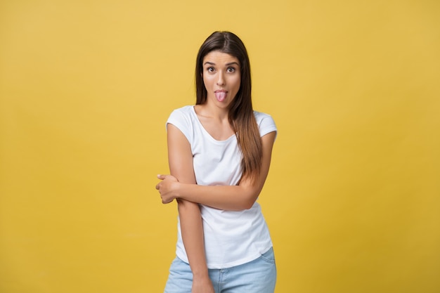 Portrait of a playful young woman with her tongue out.