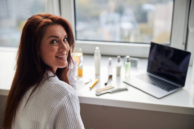 Portrait of pleased woman that doing morning procedure