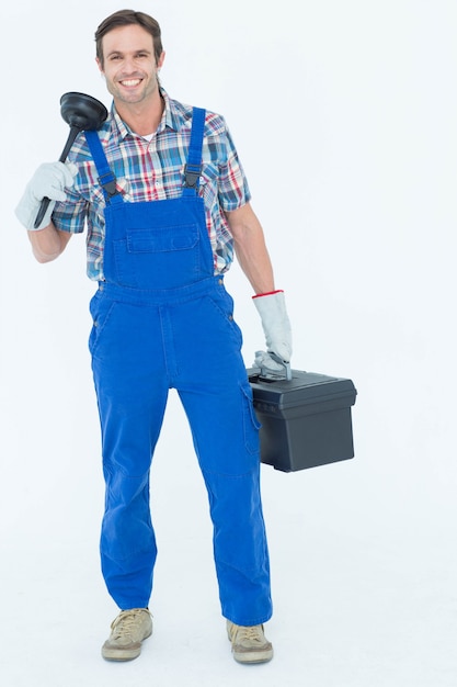 Photo portrait of plumber holding plunger and tool box