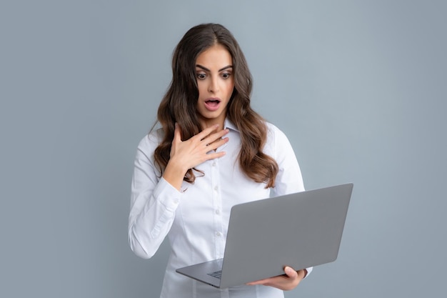 Portrait of positive cheerful ceo expert business woman work at laptop isolated over gray background